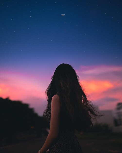 rear-view-woman-standing-against-sky-sunset_1048944-9322761.jpg