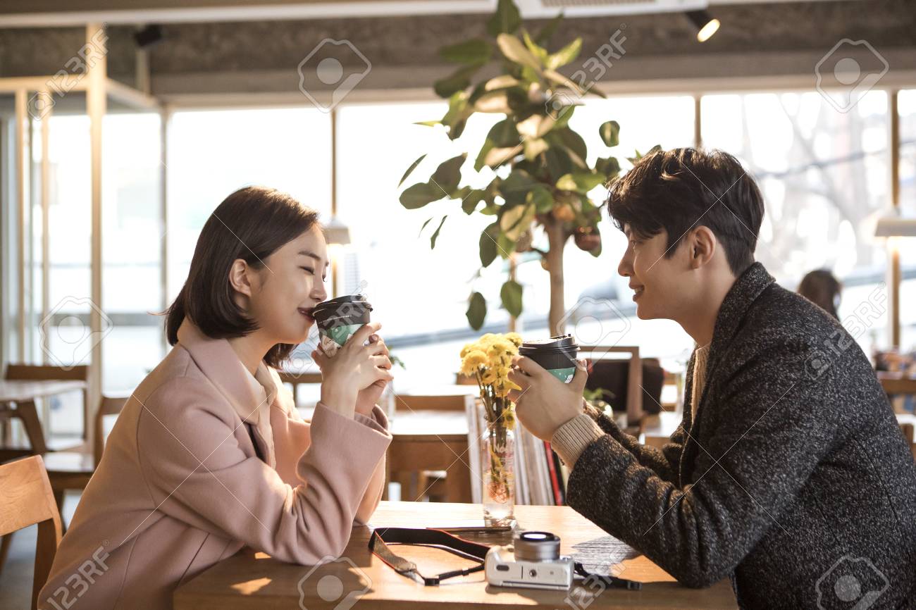 84466792-asian-couple-dating-in-coffeeshop-talking-converstaion-with-coffee.jpg